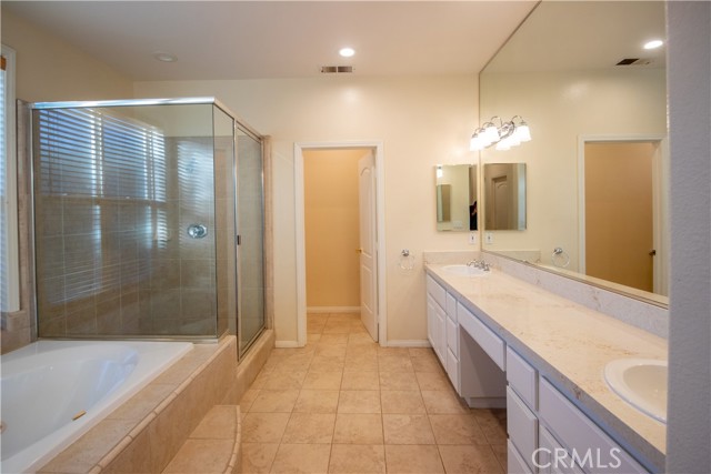 owners bathroom with tub and shower