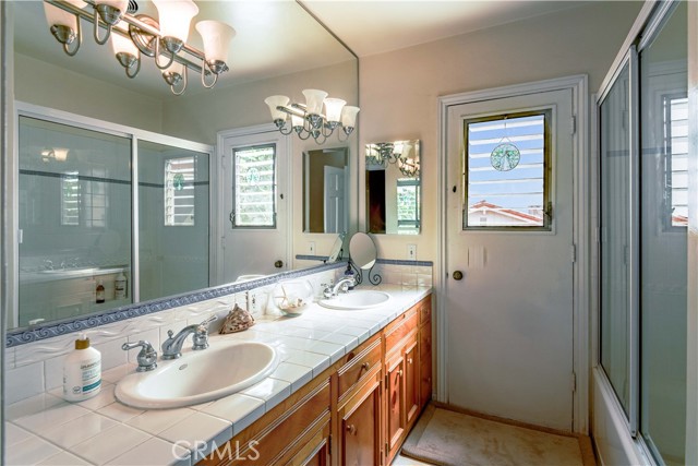 Central Bathroom with double sinks and bath/shower