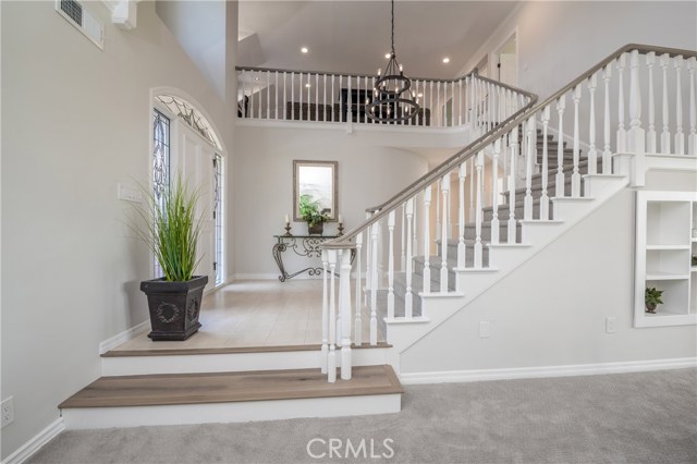 View of the entry and stairway from the front of the living room. Upstairs is the 2nd family room!
