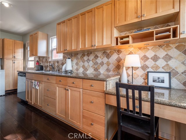 Great Kitchen with granite countertops, custom backsplash, maple cabinets. hardwood floors. Window over kitchen sink.