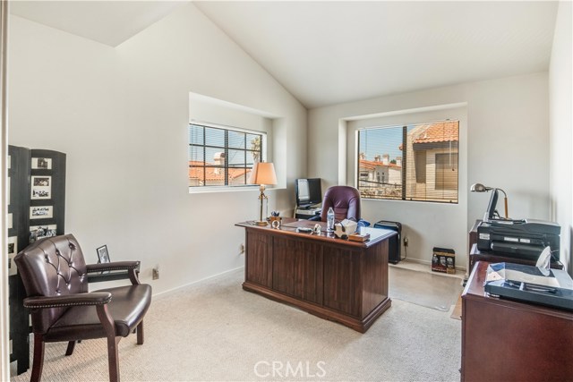 Roomy second bedroom currently used as private office has nice vaulted ceilings for that open feeling.