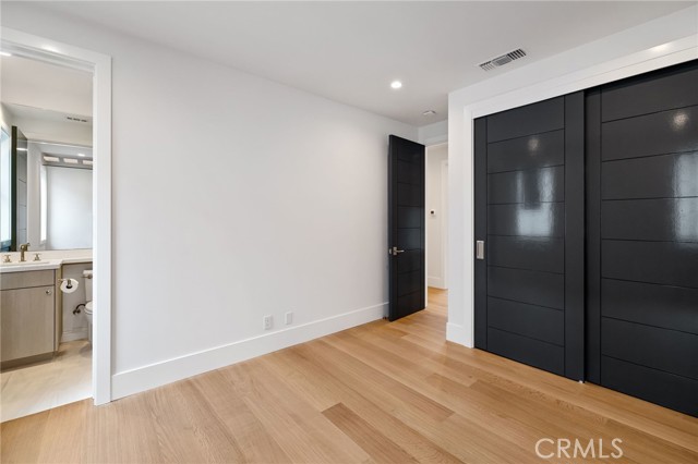 Bedroom with private bath and designer closet doors