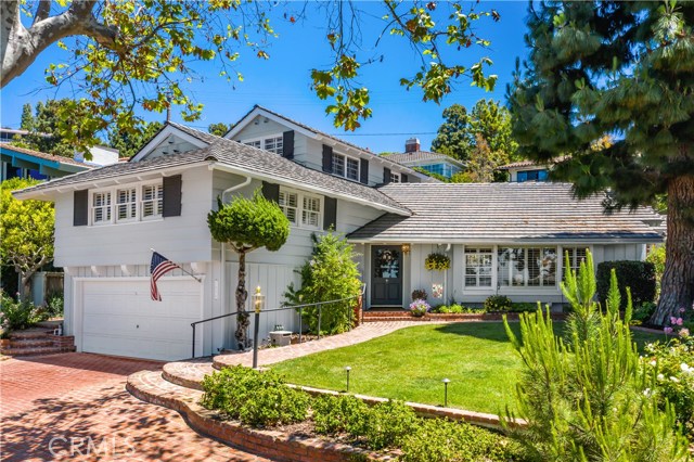 A lush and tranquil landscape surrounds as you admire the tall trees, winding roads, and ocean views that set the path to this custom-built ranch style home at 1656 Espinosa Circle.