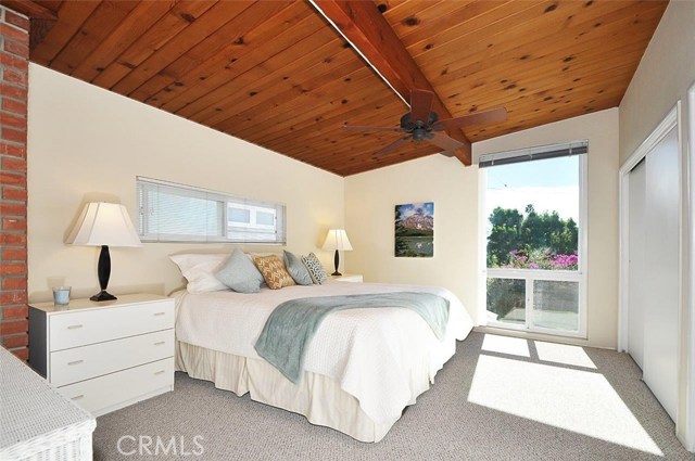 Bedroom #1 with higher ceilings and the window looking into the beautiful backyard