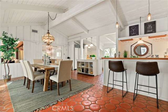 Charming spanish tile floors showcasing dining area, open wet bar and Entertainers kitchen