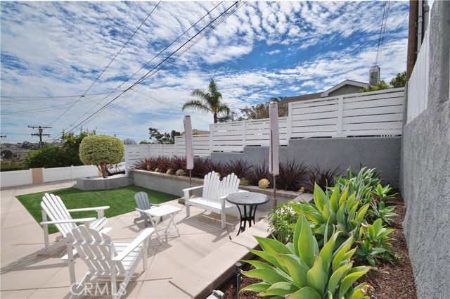 Newly added wall that inclines with sidewalk provides privacy for front yard.