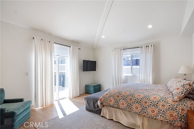 The primary bedroom has a sunny south-facing balcony, vaulted ceilings and custom window coverings.