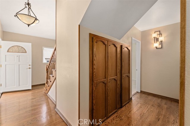 Entry leading to hall with built in storage closet and bedrooms