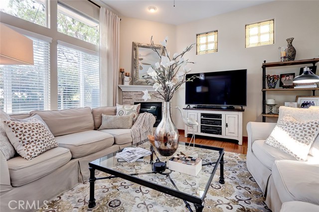 Spacious living room with ample natural light, recessed lighting and beautiful stained glass windows.