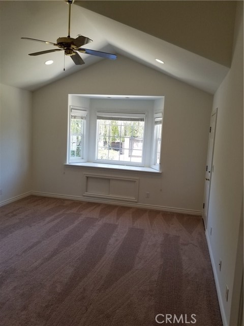 2nd Bedroom with cathedral ceiling, bay window seat, recessed lighting, ceiling fan.