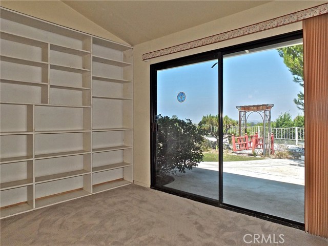 Northeast lower bedroom with built-in bookshelves, formerly utilized as the home's library.