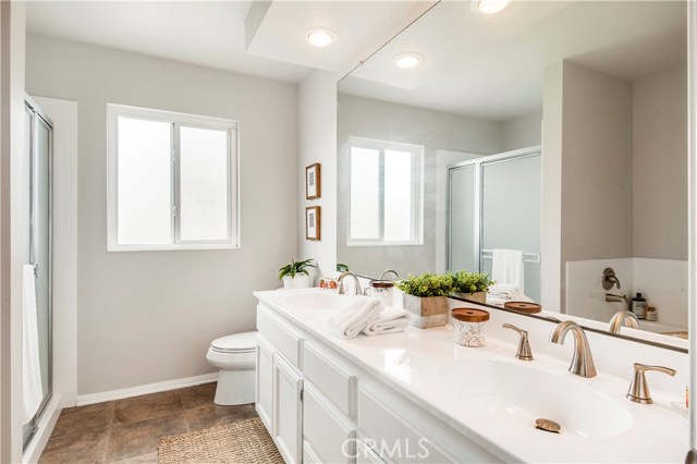 The central hall bathroom has a double sink, separate tub and shower and is adjacent to the other bedrooms.