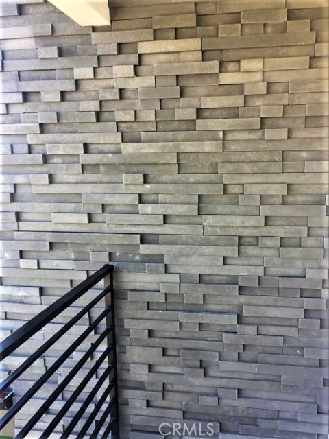 The Upper level Exterior is clad in Attractive Borel Stacked Stone Carbon Fiber Facia giving the House a Rich Contemporary Feel.
