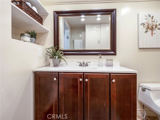 Same Bathroom, linen storage on wall behind as can be seen in mirror reflection, additional linen closets in hall