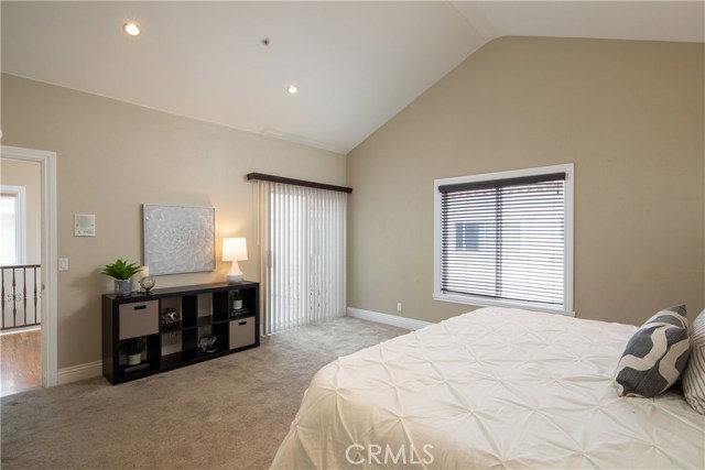 The exquisite master suite located on the upper level is a spacious room with many features including high vaulted ceilings, elegant gas fireplace, access to the deck and rooftop deck, and en-suite bathroom.