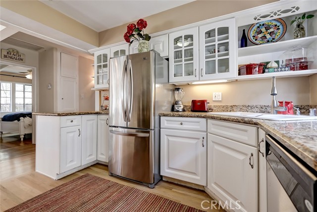 A bright kitchen with a breakfast bar overlooks the living room.