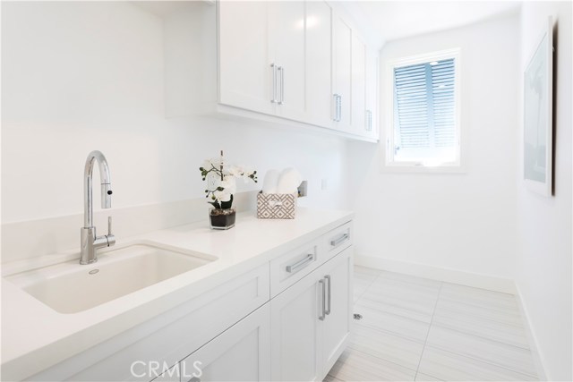 Laundry Room on bedroom floor with sink and plenty of built-ins