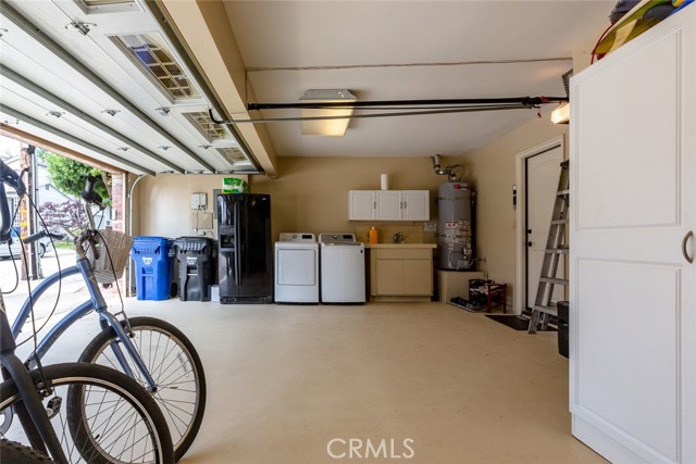 Garage contains washer, gas hook-up for dryer, and utility sink and cabinet