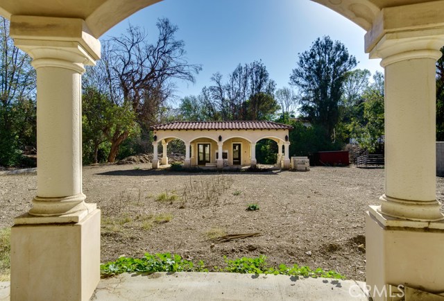 Pool house located across from the main building, with yard space for a pool.