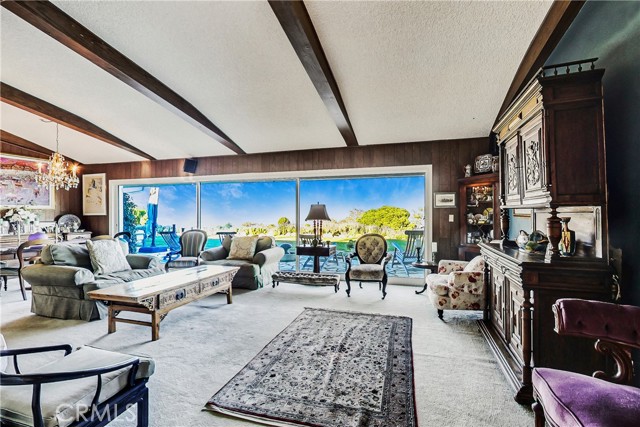 Dramatic living room/dining room features sliders that reveal the 180 degree view and combine indoor and outdoor living space.