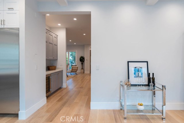 Hallway buffet and wine storage leads into another open living space