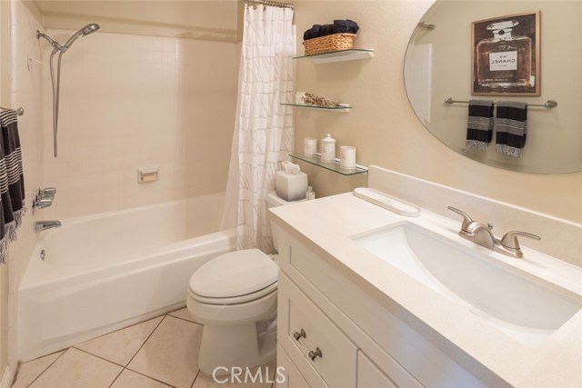 Freshly updated full bath with quartz countertop and shaker style cabinetry.