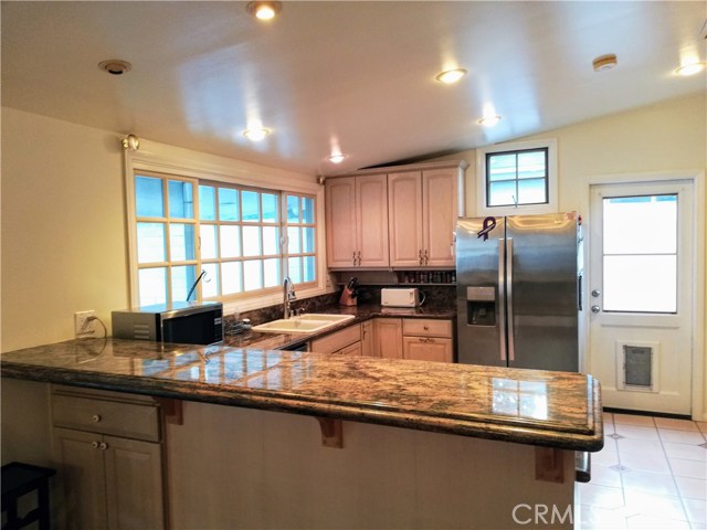 Beautiful kitchen with granite counters and plenty of cabinets.