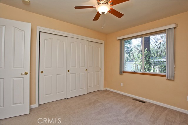 Bedroom two with spacious closet, ceiling fan and large window