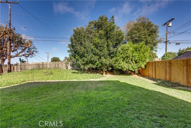 Fenced in back yard with mature trees