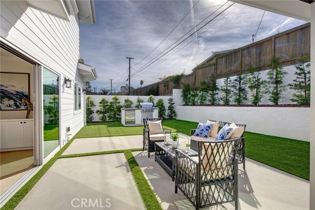 Extremely private backyard with low maintenance California landscaping with turf, drip system for plants, and built in BBQ.