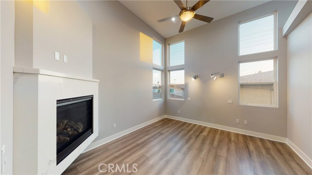 MASTER BEDROOM WITH FIREPLACE, DUAL READING LAMPS, AND CEILING FAN