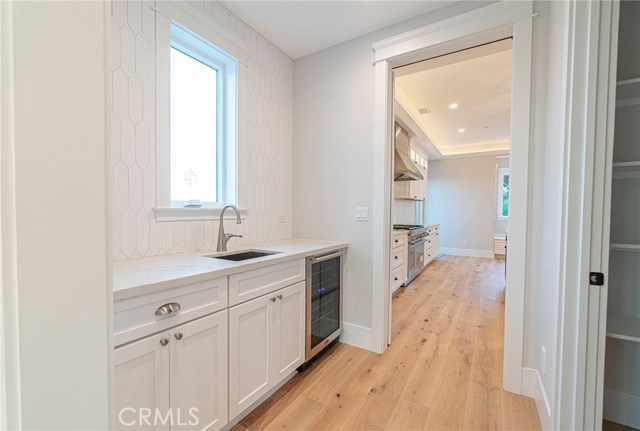 Butler's pantry, wine refrigerator and walk-in pantry on right hand side.