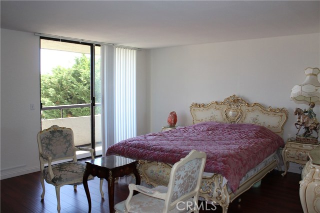 Spacious master bedroom with the view of balcony