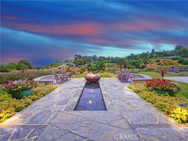 an outdoor firepit with beautiful water feature