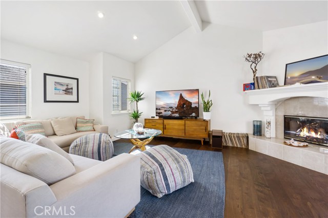 Spacious, vaulted ceiling living room with ornate fireplace