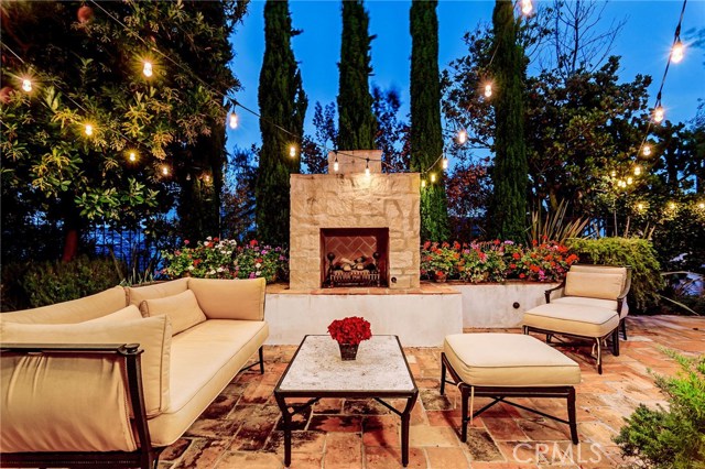 Twilight partial view of the back patio with custom built fireplace