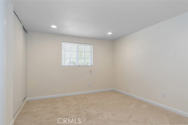 Bedroom 2 of 2 with carpet flooring and recessed lighting