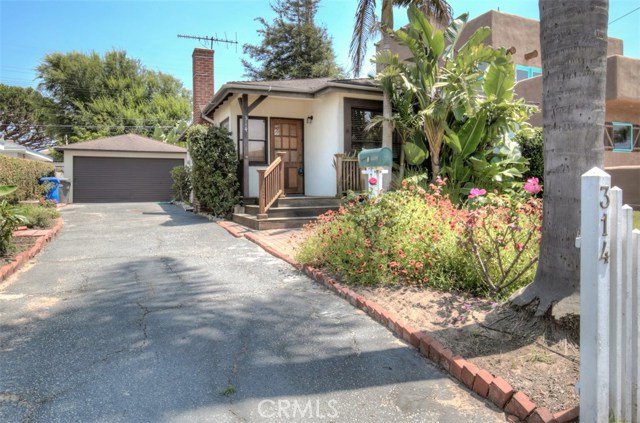 Detached two car garage with paved driveway