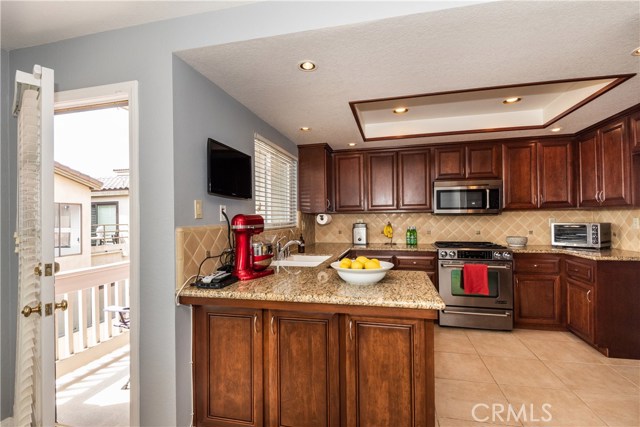Deep cabinets, expansive counter space, natural light and fresh breezes... (and another included television)