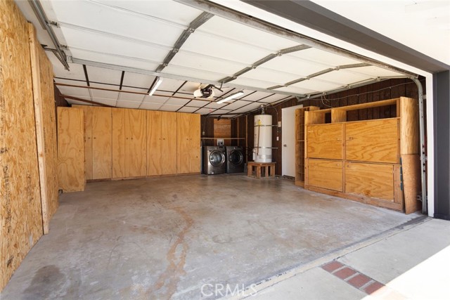 Garage picture with custom made cabinets.  Washer/Dryer in the background