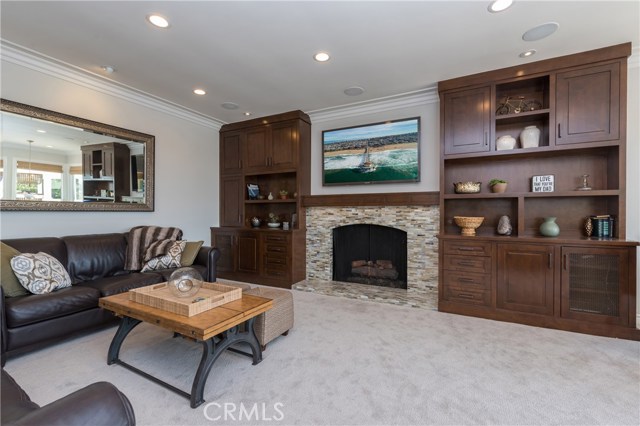 Family room has gorgeous stacked stone fireplace and fabulous custom built-in storage/display cabinets! What a great place to relax!