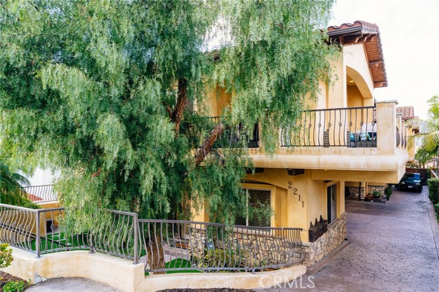 The pepper tree adds to the home's Mediterranean charm and curb appeal.