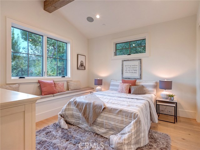 Upstairs bedroom suite #3, with bench, Trestlewood reclaimed wood accent beam and en-suite bathroom.