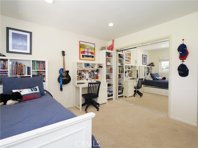 Secondary bedroom #2 with mirrored closet doors