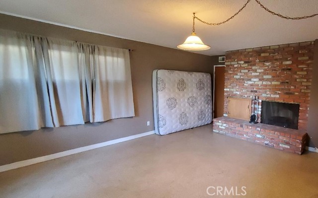 Downstairs Family room with beautiful used brick fireplace