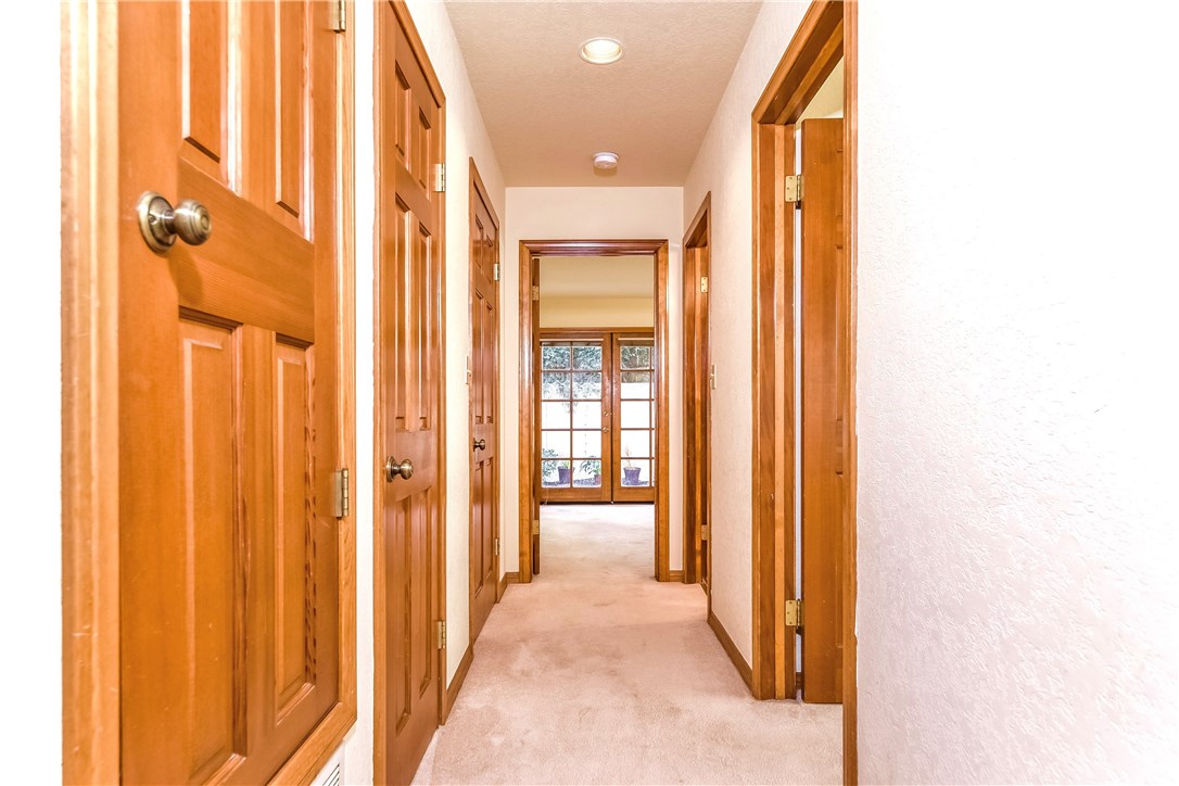 The lower level hallway leads to two bedrooms and a full bath. The are hall closets offering lots of storage and the rear bedroom opens onto a nice rear yard area.