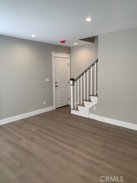 Living room view facing staircase to upstairs and to garage.