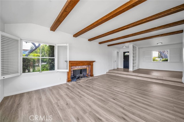 From the south-west corner of the living room  - fireplace, front door and dining area