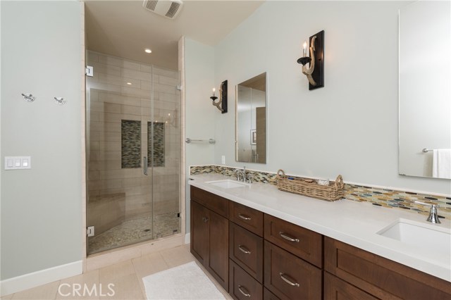 Huge master bath has large walk-in shower, and separate soaking tub and commode room. Quartz counters with pretty tile backsplash!