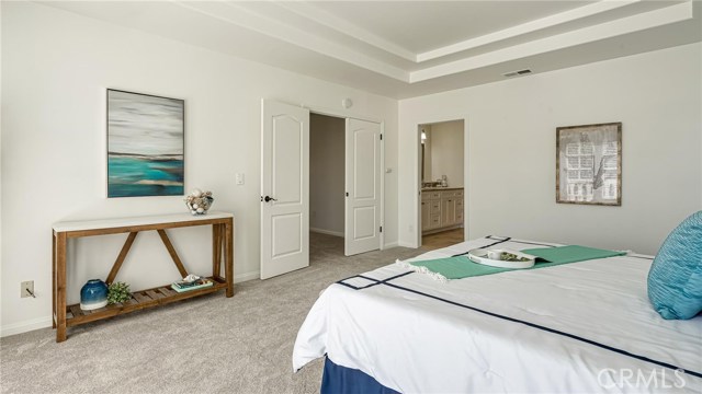 Enormous master bedroom facing double door entry and entry into the master bathroom.